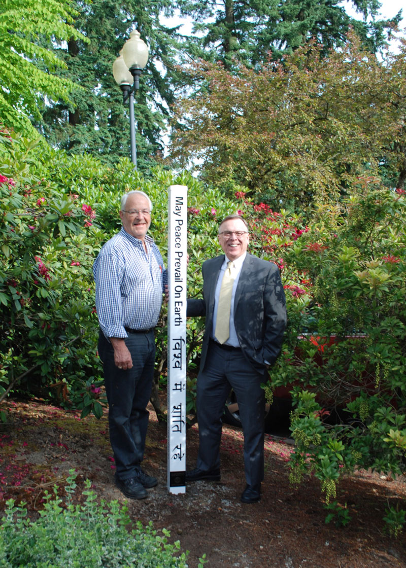 Lakewood President Don Plumb and Lakewood Exec. Director Andrew Edwards with new Peace Pole at Lakewood Center for the Arts