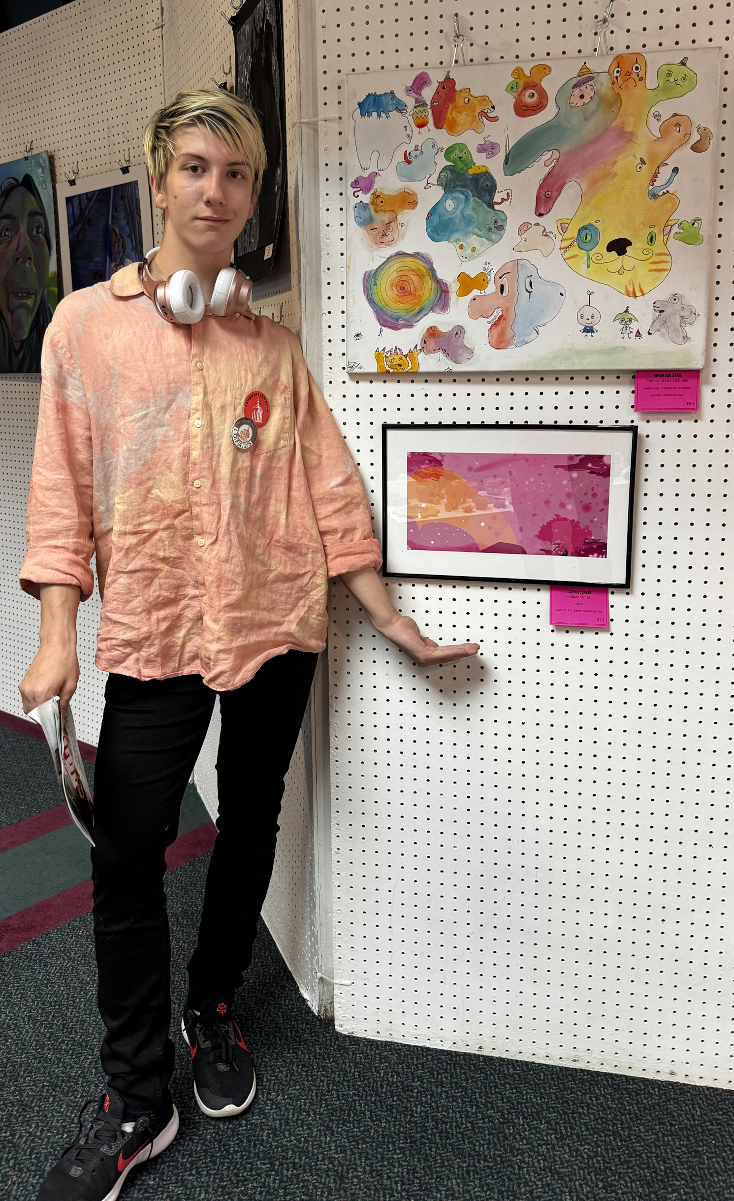 Artist Calvin O'Connor standing with his artwork